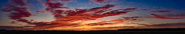 Sunset with red coloured clouds on the evening of the solstice