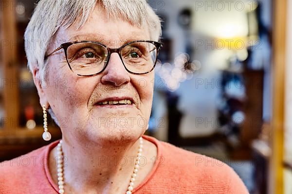 Portrait of a senior citizen with glasses at home