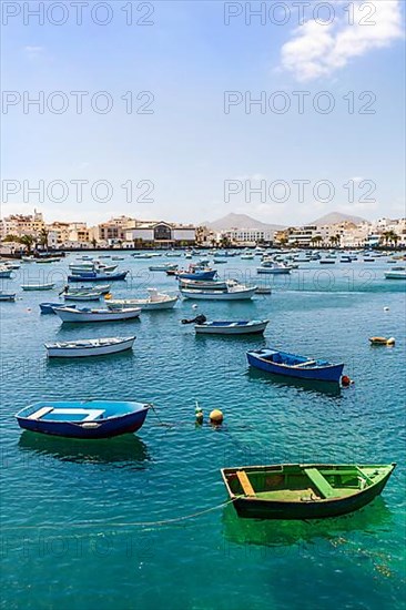 Beautiful seaside downtown of Arrecife with many boats floating on blue water