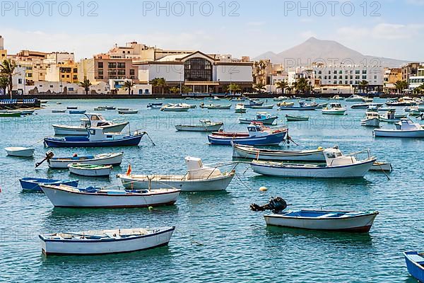 Beautiful seaside downtown of Arrecife with many boats floating on blue water