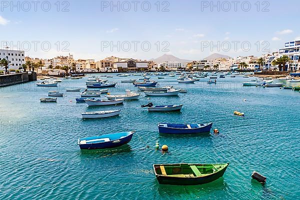 Beautiful seaside downtown of Arrecife with many boats floating on blue water