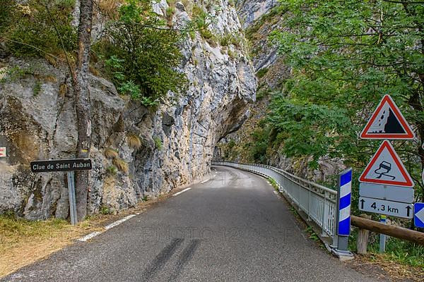 Traffic signs Warning signs at entrance of narrow road through narrow gorge Clue de St. -Auban with overhanging rock