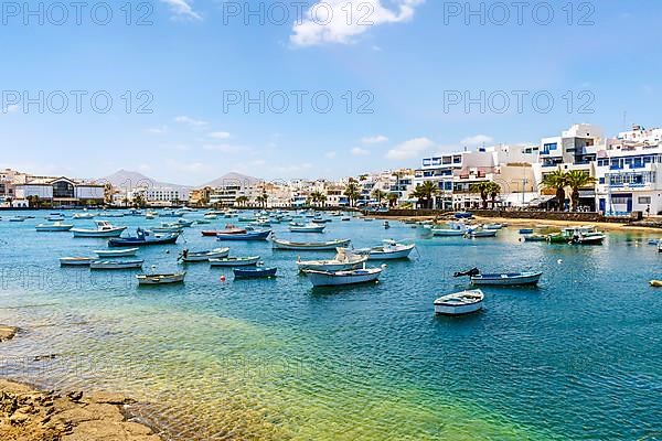 Beautiful seaside downtown of Arrecife with many boats floating on blue water