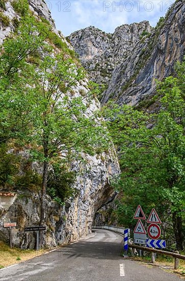 Traffic signs Warning signs at entrance of narrow road through narrow gorge Clue de St. -Auban with overhanging rock