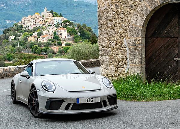 Supercar sports car Porsche GT3 in tight curve of historic track section of Rallye Monte Carlo 1965