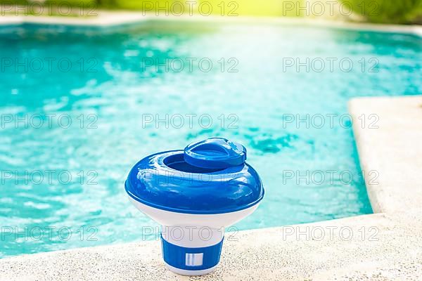 A chlorine dispenser for swimming pools with blue water in the background. Dosing float for swimming pool chlorination
