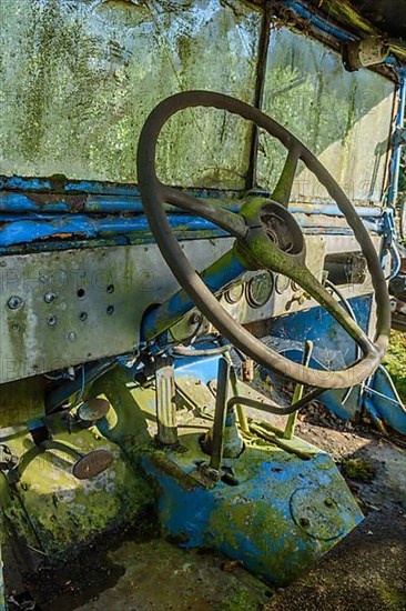 Old car rolled for scrapping in a meadow. Alsace