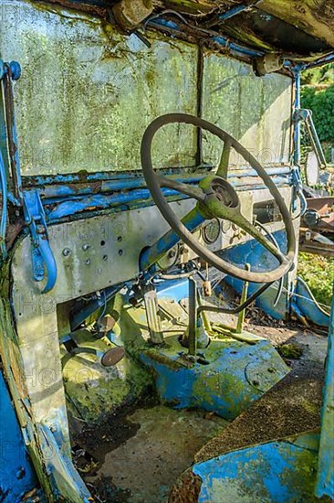 Old car rolled for scrapping in a meadow. Alsace