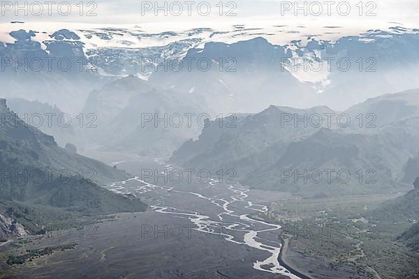 View into mountain valley with glacier river Krossa and glacier Myrdalsjoekull