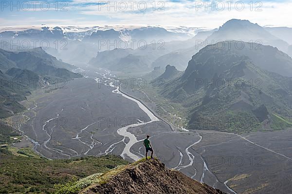 Hiker in front of mountain landscape