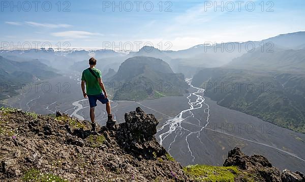 Hikers in front of mountain landscape