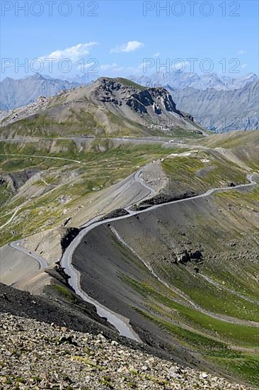 View from Cime de la Bonette on high alpine mountain landscape with alpine pass Col de la Bonette in the middle