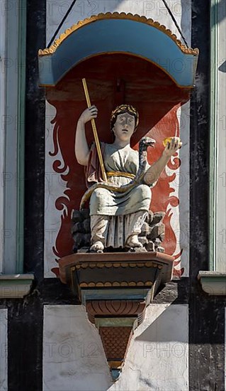 Figure with bowl and staff at the Rats-Apotheke