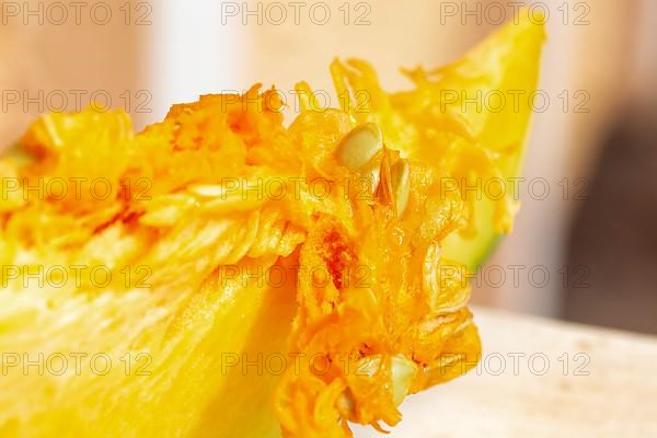 Macro shot of sliced pumpkin with pulp and seeds