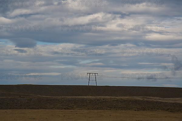 Power line in barren landscape near the ring road
