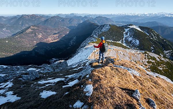 Climbers on the summit ridge with first snow in autumn