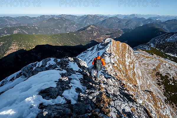 Climbers on the summit ridge with first snow in autumn