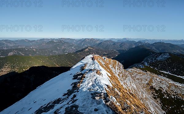 Climbers on the summit ridge with first snow in autumn