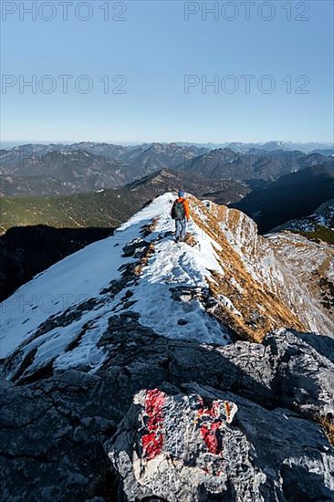 Climbers on the summit ridge with first snow in autumn