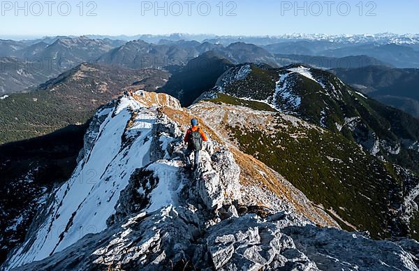 Climbers on the summit ridge with first snow in autumn