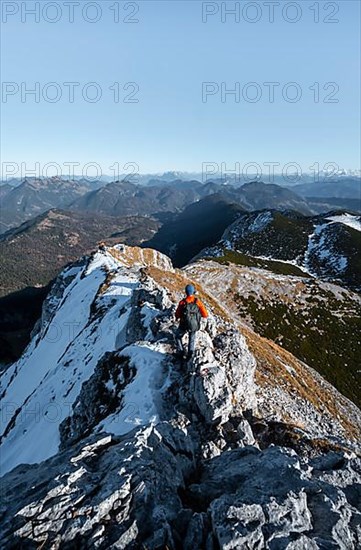 Climbers on the summit ridge with first snow in autumn