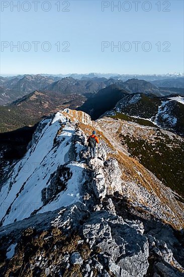 Climbers on the summit ridge with first snow in autumn