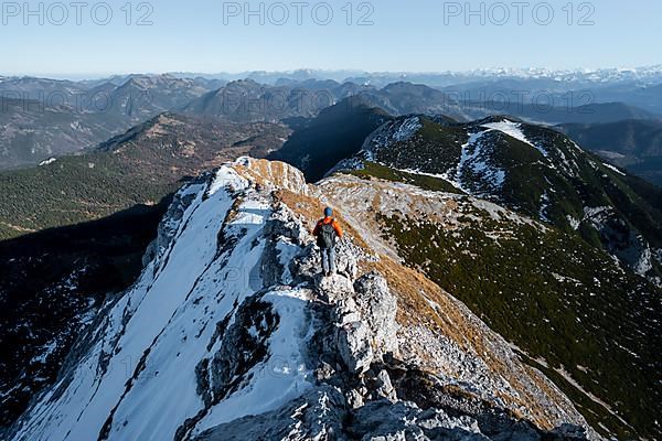 Climbers on the summit ridge with first snow in autumn