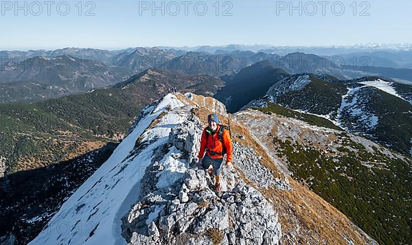 Climbers on the summit ridge with first snow in autumn