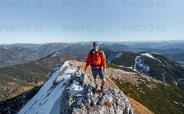 Climbers on the summit ridge with first snow in autumn