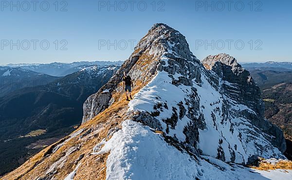 Climbers on the summit ridge with first snow in autumn