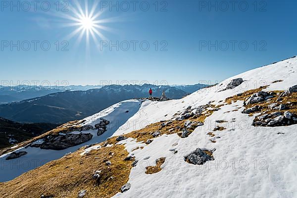 Hiker next to a cairn