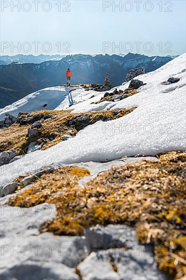 Mountaineer next to a cairn