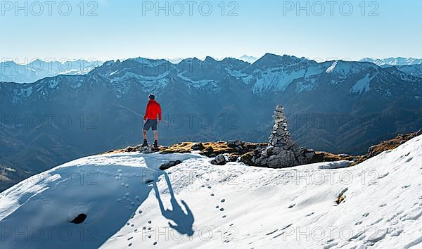 Mountaineer next to a cairn