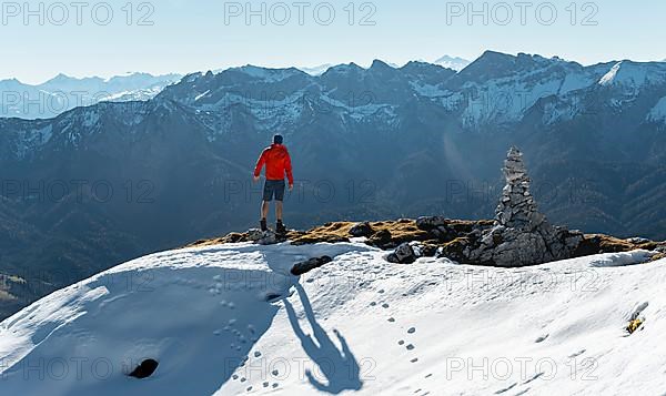 Mountaineer next to a cairn