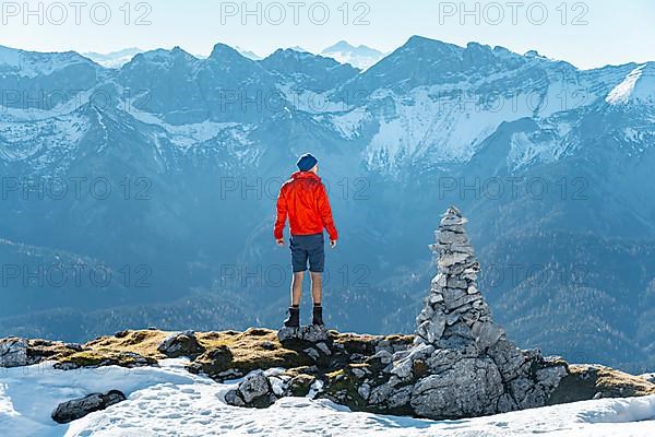 Mountaineer next to a cairn