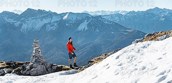 Mountaineer next to a cairn