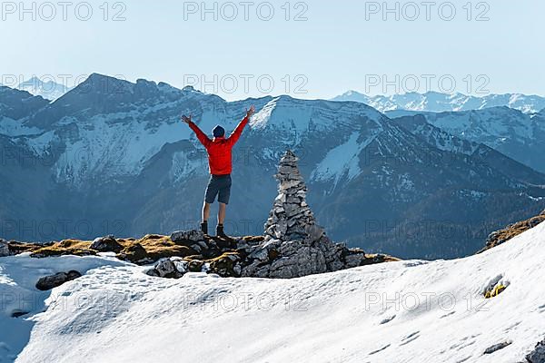 Mountaineer stretching his arms in the air