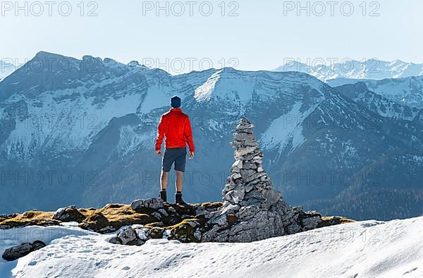 Mountaineer next to a cairn