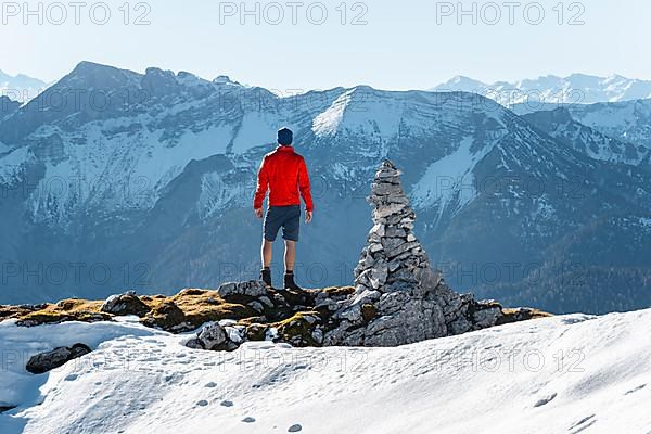 Mountaineer next to a cairn