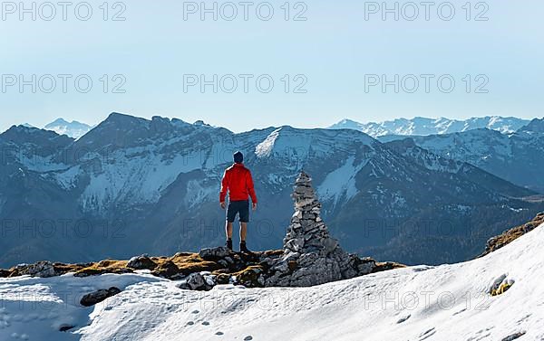 Mountaineer next to a cairn