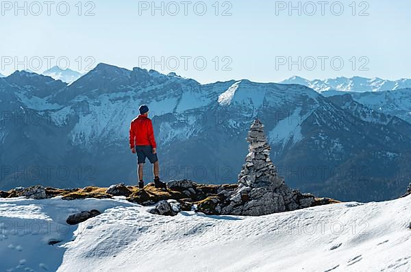 Mountaineer next to a cairn