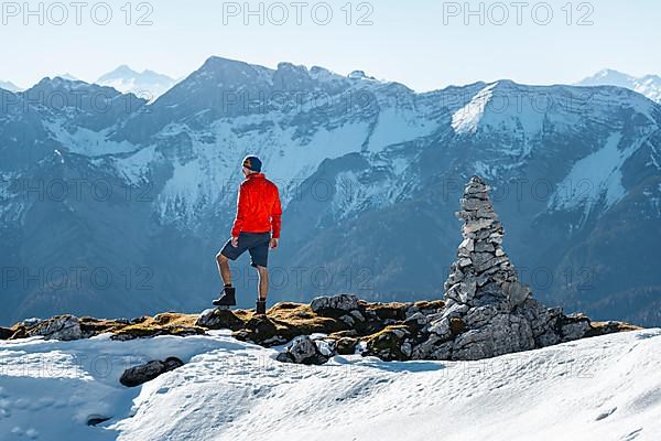 Mountaineer next to a cairn