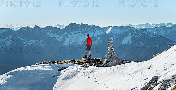 Mountaineer next to a cairn