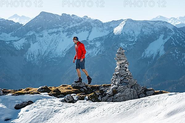 Mountaineer next to a cairn