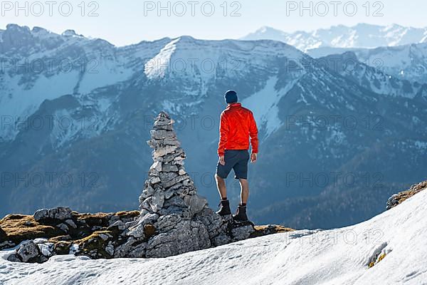 Mountaineer next to a cairn