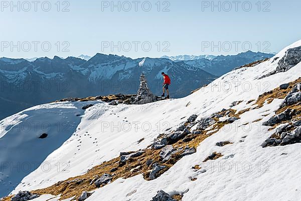 Mountaineer next to a cairn