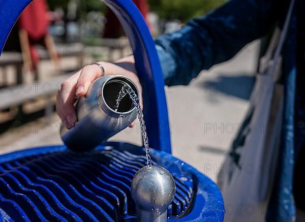 Blue fountain with drinking water dispenser on a public square