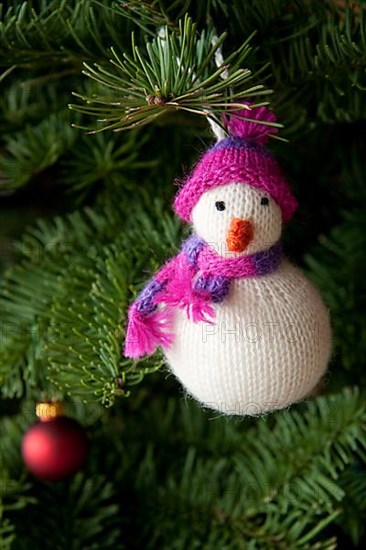 Snowman hanging on Christmas tree