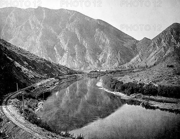 Mountainous landscape in the background and the railway line along the Jefferson Canon in the state of Montana