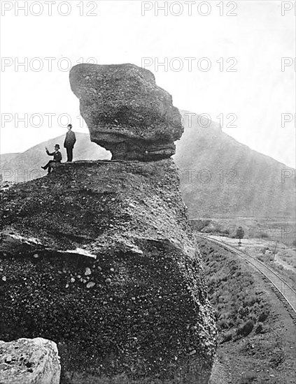 Men next to the rock formation